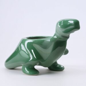 Zielona doniczka w kształcie dinozaura